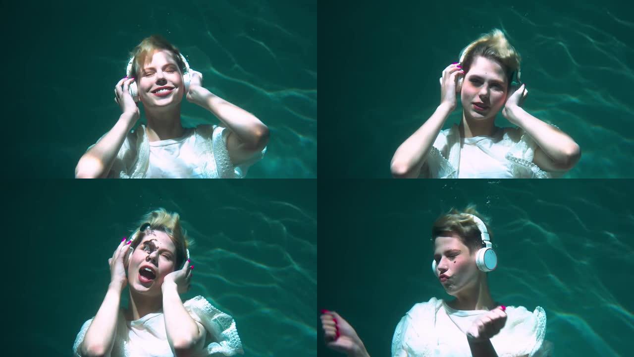 快乐美丽的年轻女子在水下慢动作下闭着眼睛听音乐的电影视图。