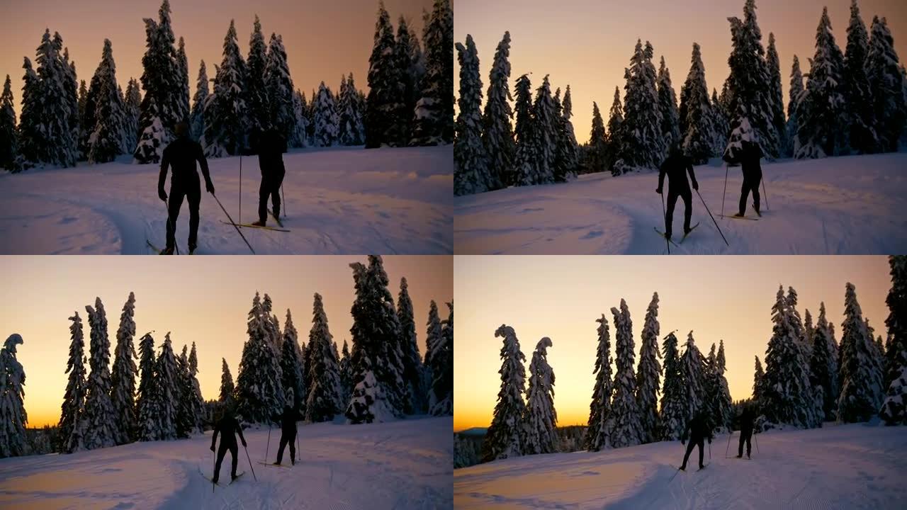 SLO MO两名无法识别的越野滑雪者在日落时滑雪