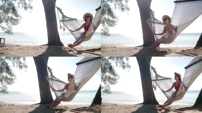 年轻女子在热带岛屿的吊床上放松