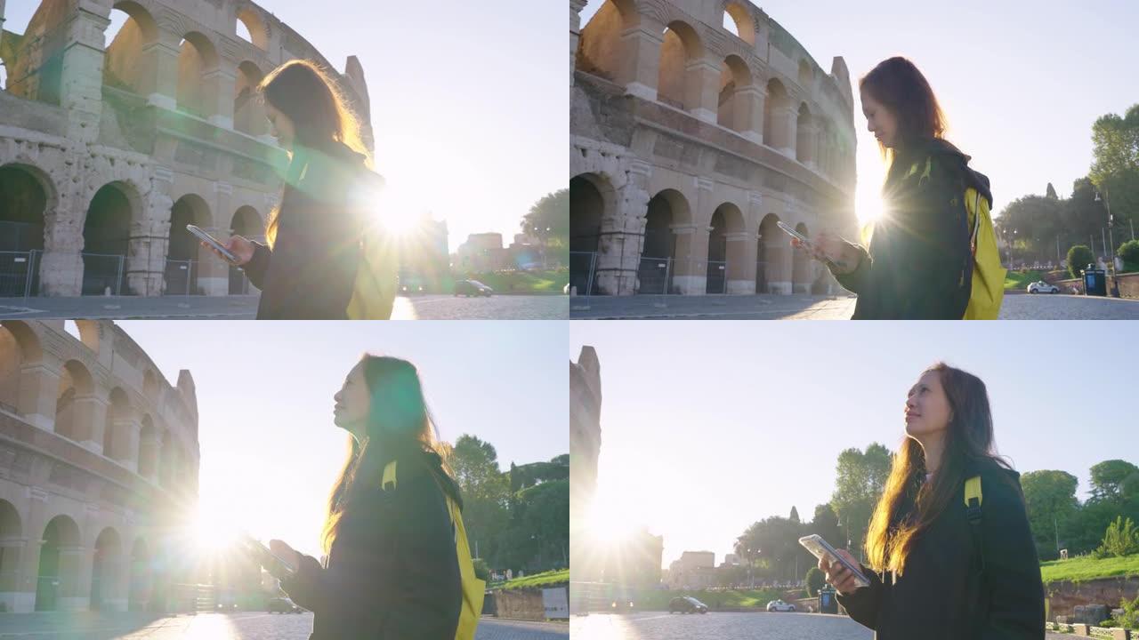 快乐的年轻女性游客使用手机到意大利罗马罗马竞技场的意大利著名地标。体验旅行与多样性。与阿尔法。