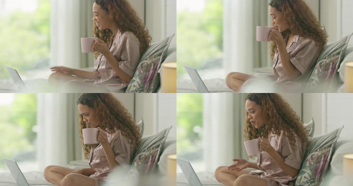 4k视频片段，一名年轻女子在家里躺在床上喝咖啡时使用笔记本电脑进行视频通话
