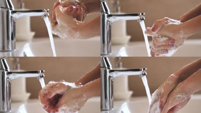 特写镜头，一名年轻女子在用打开水龙头洗手时用肥皂洗手以达到卫生目的