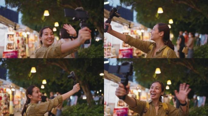年轻女子在泰国夜市拍摄vlog自拍照