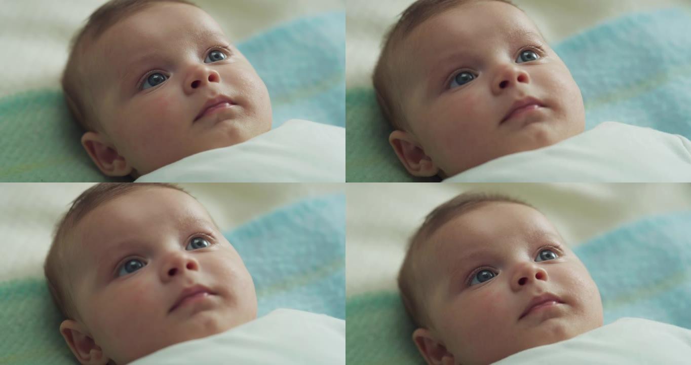 可爱的蓝眼睛新生男婴的电影真实特写镜头在镜头中微笑着。孩子，婴儿，父母身份，童年，生活，家庭，未来的