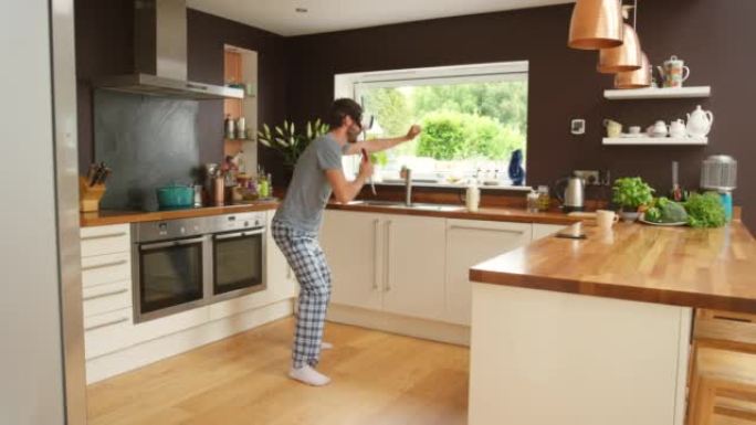 4k视频片段，一名男子戴着VR耳机在厨房里跳舞