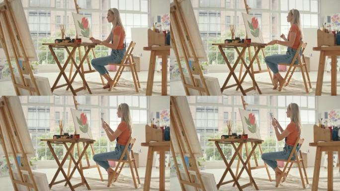 艺术家使用电话拍摄她的油画，并在社交媒体上发布。有创造力的有才华的女画家使用技术从她的家庭工作室推销