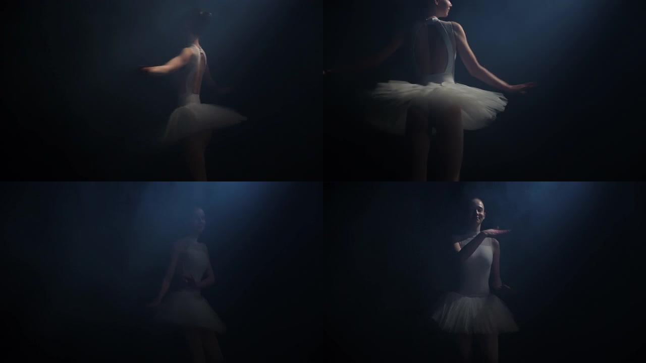 年轻的芭蕾舞女舞者在工作室的黑暗中旋转