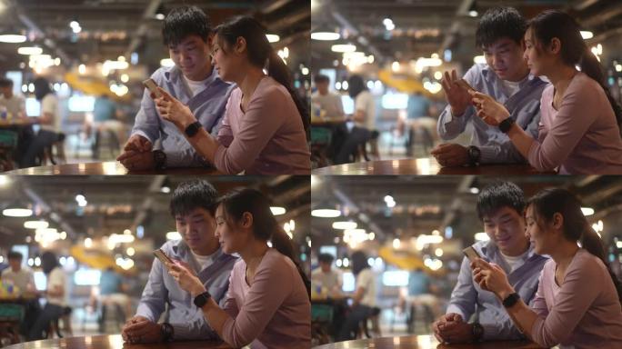 亚洲情侣用手机和分享屏