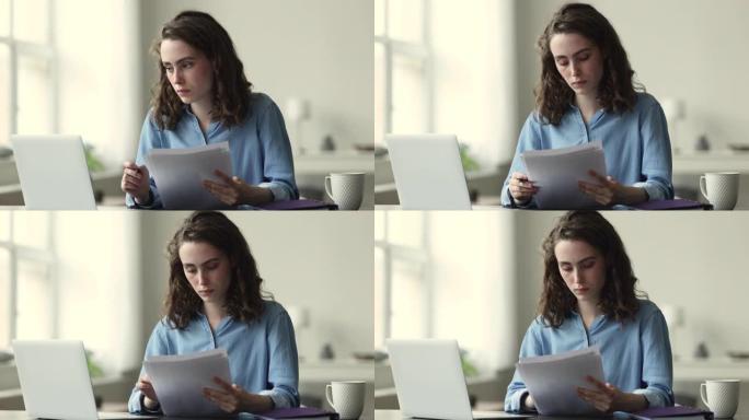 处理论文，学习的女人坐在笔记本电脑的桌子上