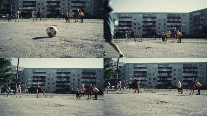 附近的孩子在城市后院外面踢足球。年轻足球运动员点球。多元文化的朋友在郊区一起踢足球。冷去饱和颜色分级
