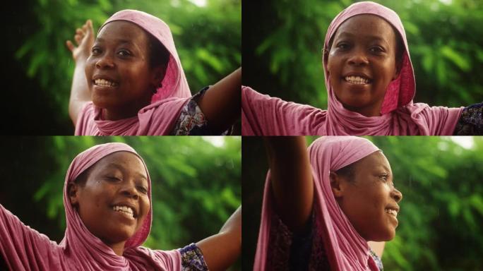 一个来自农村的非洲妇女的肖像，有模糊的绿色背景，感觉被水刷新。快乐的黑人女农民在长期干旱后欢迎雨水