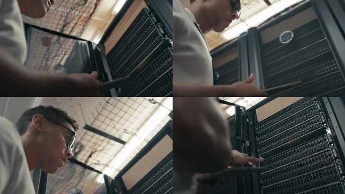 一名年轻技术人员在服务器机房执行维护检查时使用数字平板电脑的4k视频片段