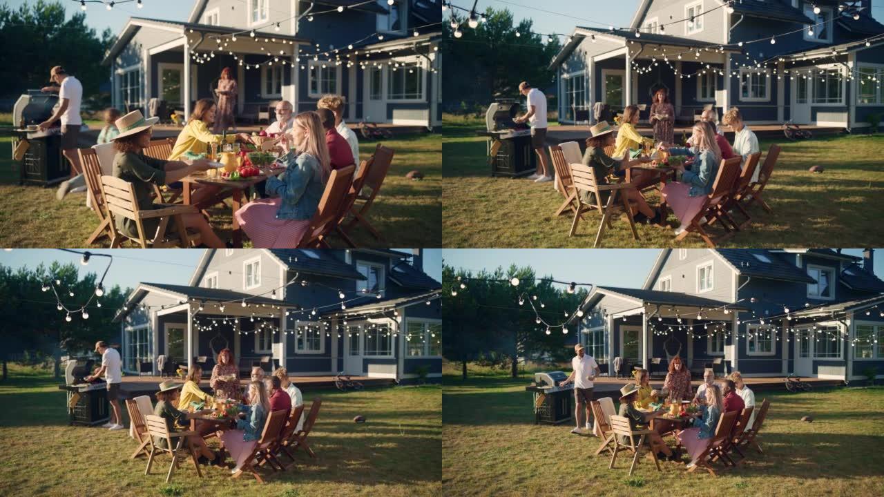 父母，孩子和朋友聚集在美丽家园外的烧烤餐桌旁。老人和年轻人玩得开心，吃喝。后院的花园派对庆祝活动。慢