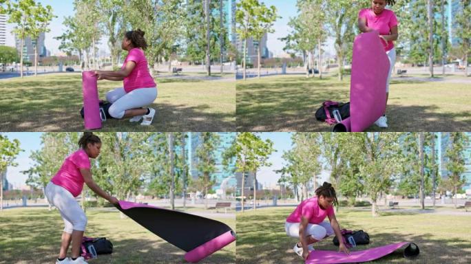 20多岁的孕妇在公园放下运动垫
