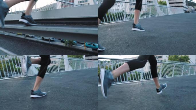 健身女性的脚穿着跑鞋，在城市的一座桥上快速跑上楼梯，同时进行有氧运动训练。运动的女性活跃并锻炼以保持