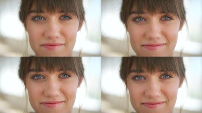 一位美丽的年轻女子的肖像，蓝眼睛对着镜头微笑。自信，无忧无虑的高加索女性脸上的特写镜头，心情愉快，乐