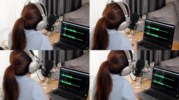 后视图。女人播客录音和编辑手提电脑上的声波设计