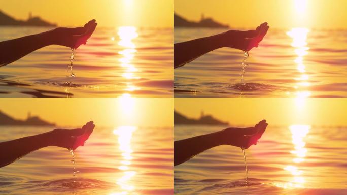 特写: 度假的女游客在日出时举起少量海水。