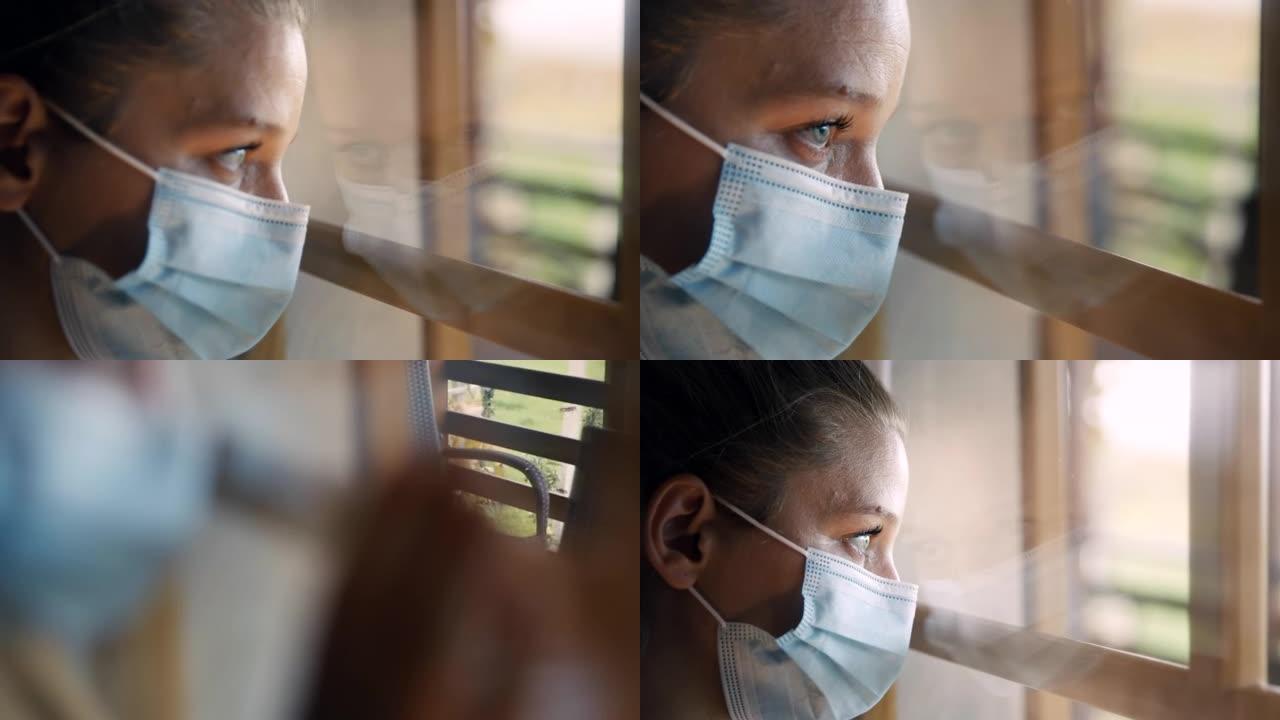 戴着面具的SLO MO忧郁的女人透过窗户看，回想起新型冠状病毒肺炎封锁期间的自由