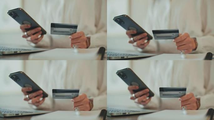 用信用卡从手机上在线订购的特写手女人
