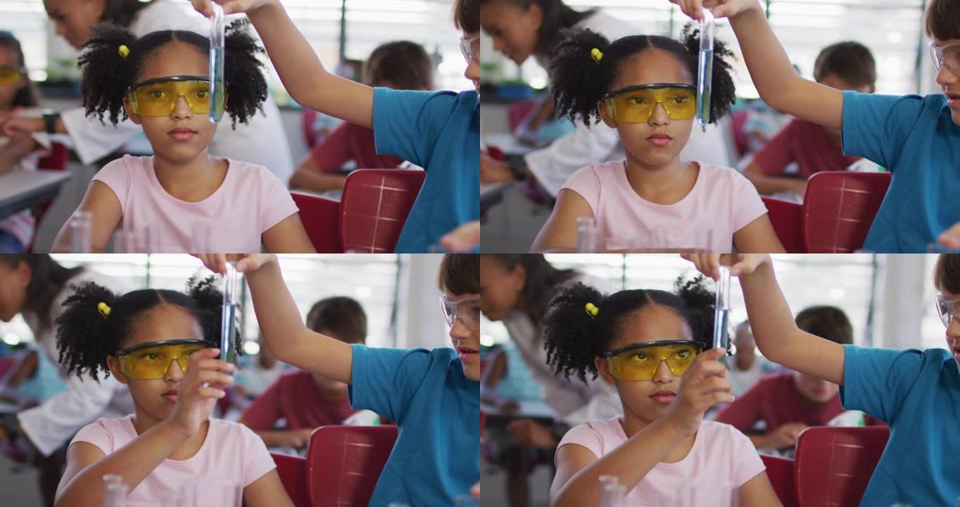 化学课上戴着防护眼镜的多样化种族学童拿着试管