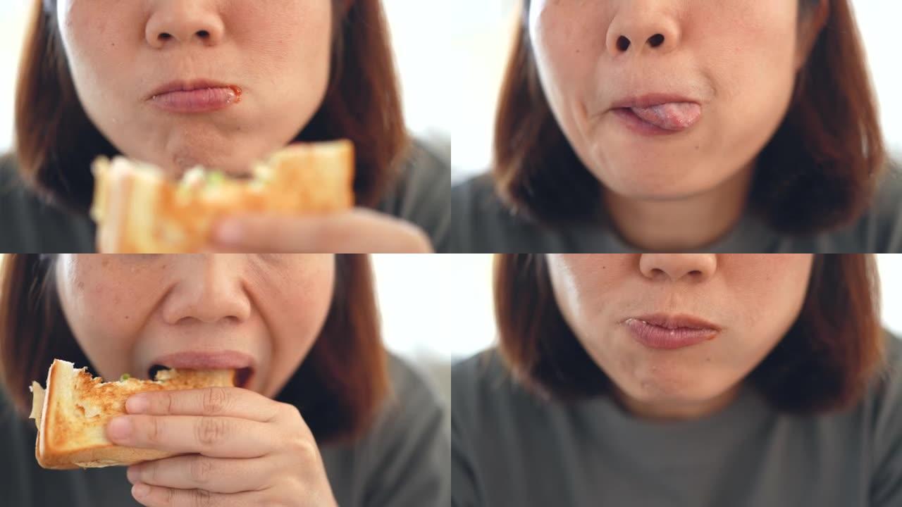 女人的脸在吃三明治