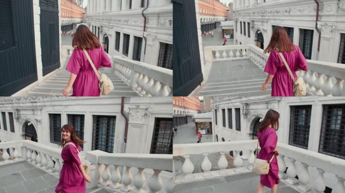 镜头跟随美丽快乐的年轻高加索旅行家女人在暑假沿着威尼斯著名的里亚托桥奔跑。