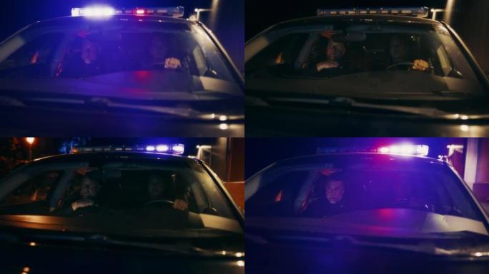 视点:夜班两名值班警察驾驶着交通巡逻车，警报器响了闪光灯，开始追捕一名嫌疑人。追捕罪犯的警车警察。电