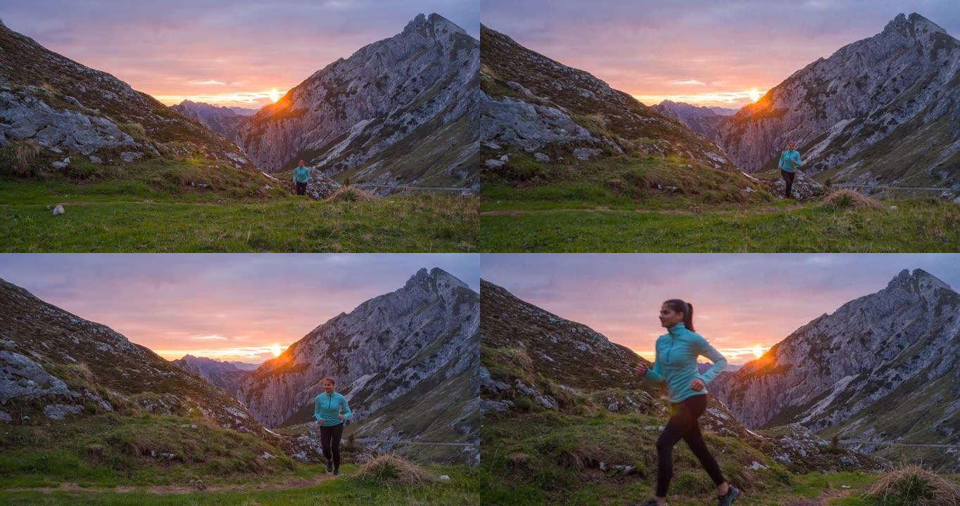 运动活跃的女人在日落时在山区的岩石小径和草坡上慢跑