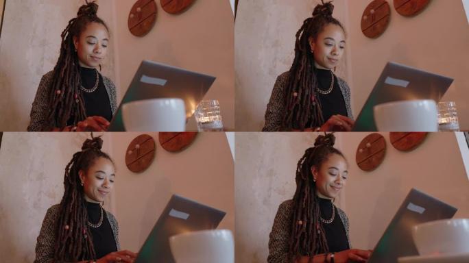 年轻女性自由职业者在wifi咖啡馆使用笔记本电脑