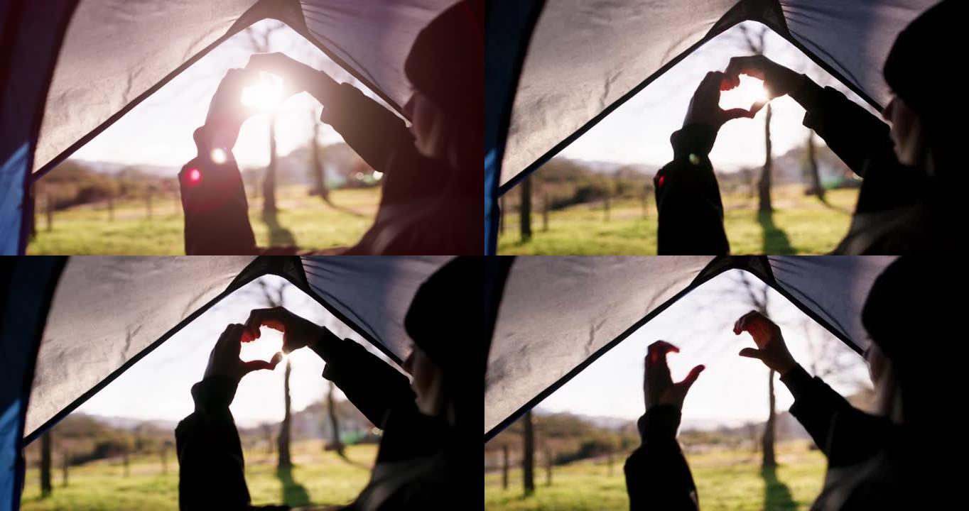 4k视频，一个女人用手在帐篷上做心形