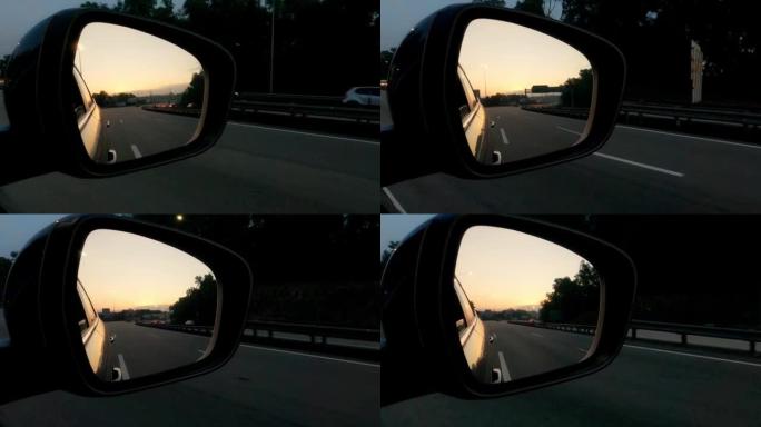 展示美丽日落的汽车后视镜