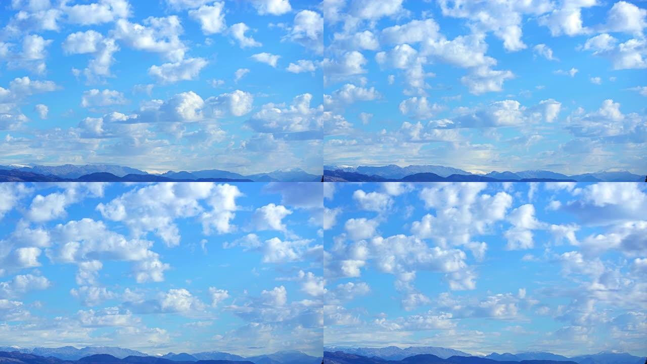 山脉上方蓝天上美丽的云背景时间流逝