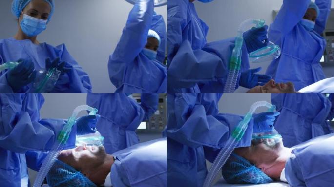 外科医生穿着防护服，在医院手术期间用气体镇静白人男性患者