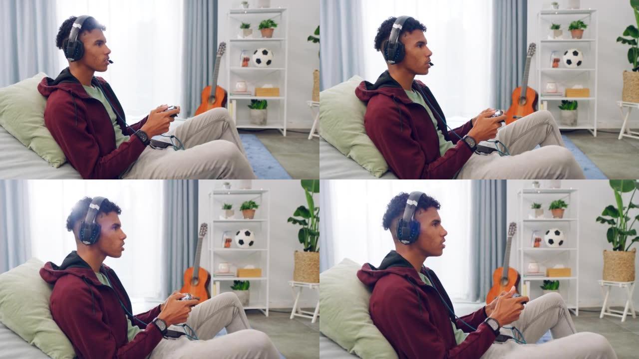 一位年轻的游戏玩家坐在沙发上玩游戏机视频游戏，并在无线耳机上聊天。使用控制器在线玩多人游戏，同时看起