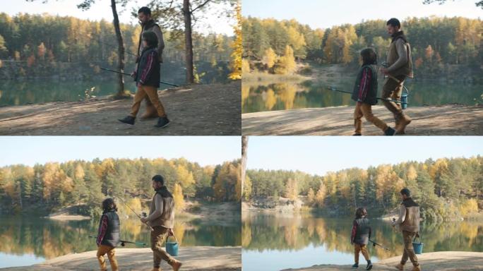 爸爸和可爱的孩子带着钓鱼竿在秋天的日子里走向美丽的湖泊