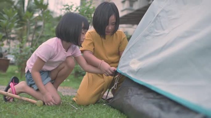 亚洲华人家庭2姐妹在自家后院露营周末活动
