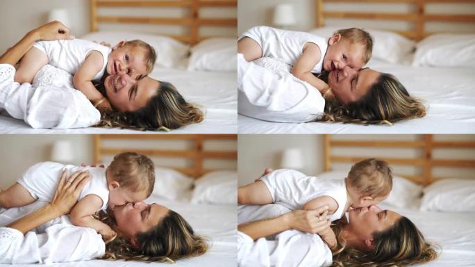 一位年轻快乐微笑的neo母亲的真实照片很喜欢在卧室里和她刚出生的婴儿玩得开心
