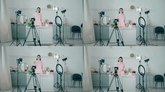 年轻女子正在专业工作室拍摄烹饪vlog