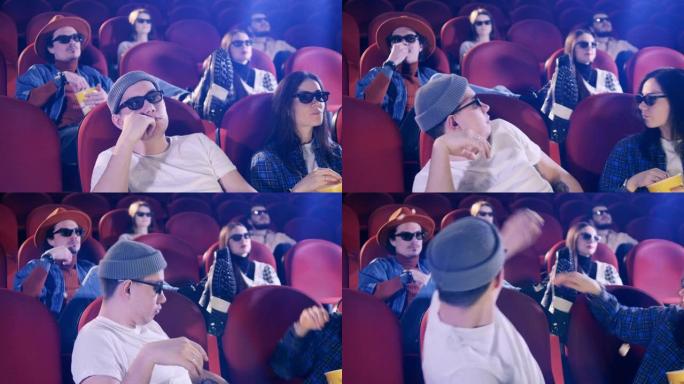 人们在电影院里互相扔爆米花。电影，电影，娱乐概念。