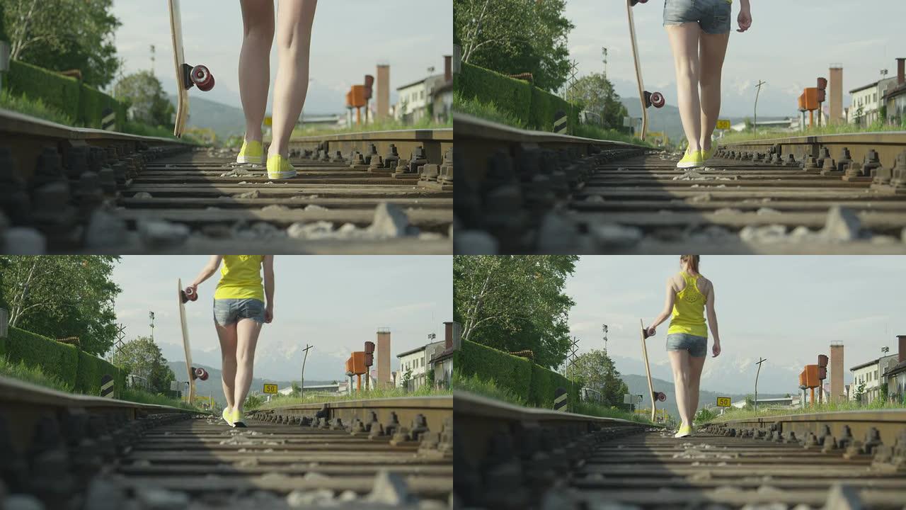 慢动作: 女人拿着长板在铁路上行走