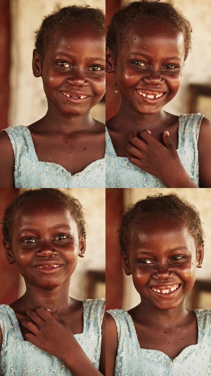 一个害羞的真实的非洲女孩的特写肖像，对着模糊背景的相机微笑。对未来充满希望的黑人女性与世界团结