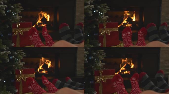 特写情侣，脚上穿着圣诞袜，在壁炉旁放松