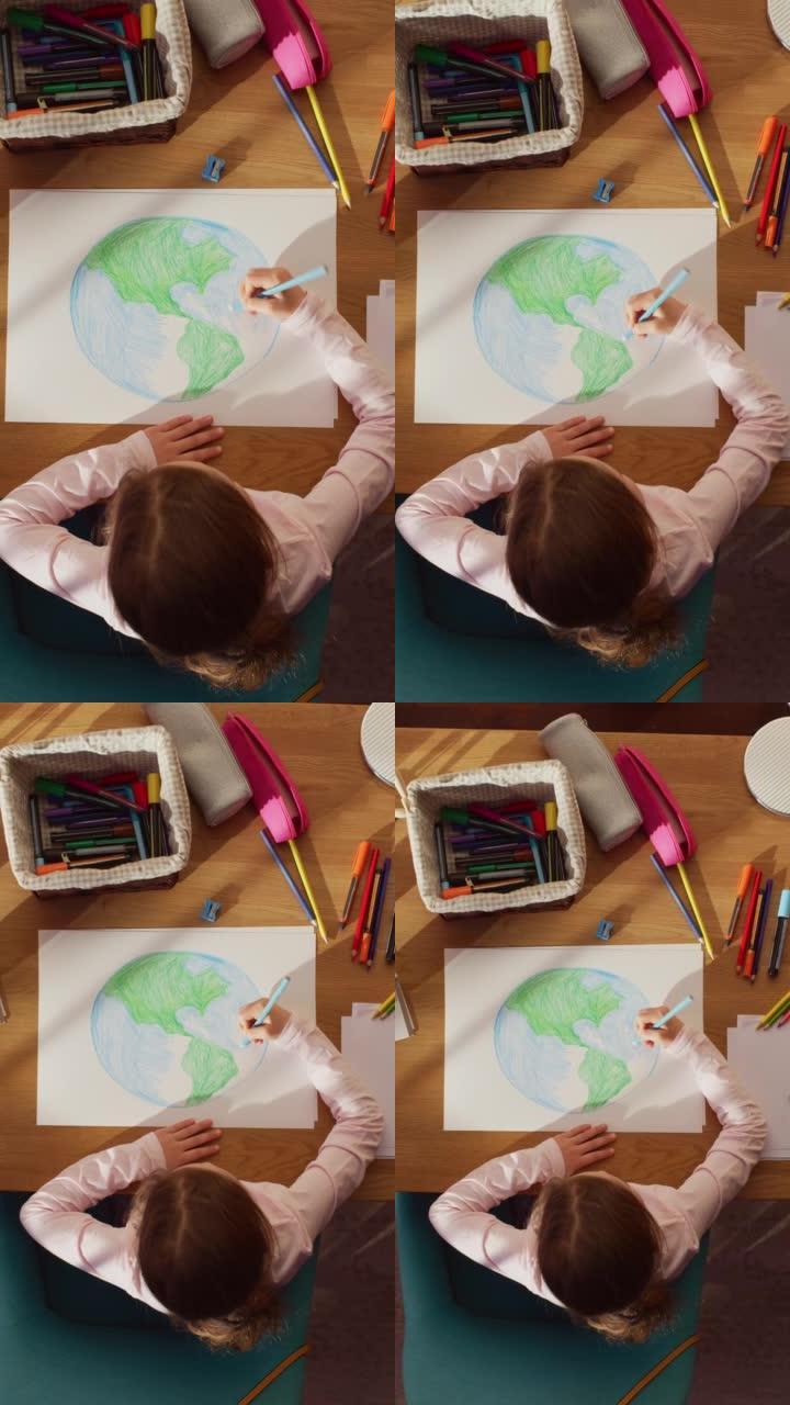 俯视图垂直屏幕: 高加索女孩画我们美丽的地球。非常有才华的孩子在家里玩得开心，想象我们的家乡星球是一