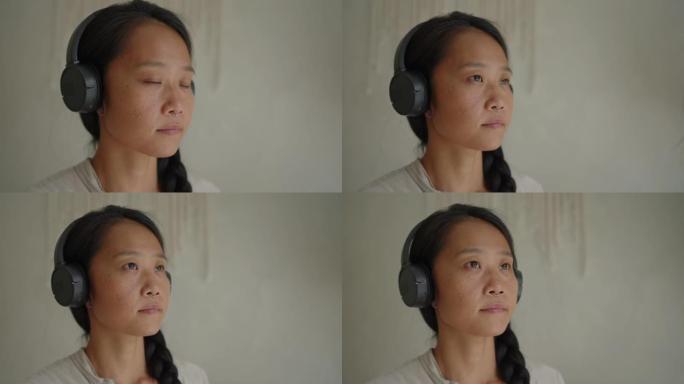 日本女性一边冥想一边听耳机放松的音乐
