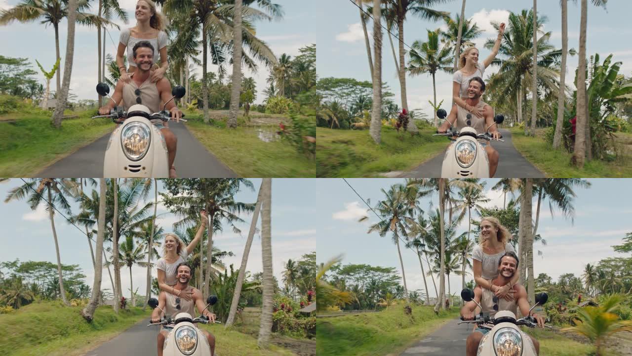 旅行情侣骑滑板车在热带岛屿上快乐的女人举起手臂庆祝享受有趣的假期公路旅行和男朋友骑摩托车