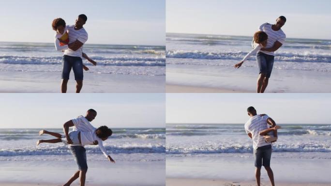 非裔美国父亲接儿子在海滩玩耍