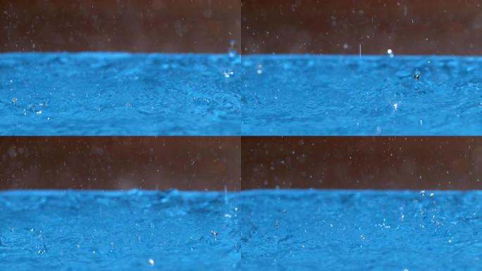 宏观: 清澈的雨滴会在空水池的表面上产生涟漪效应。