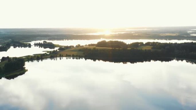 史诗般的日出全景，无人机在夏天白俄罗斯令人难以置信的仍然安静的大湖上飞越小岛。