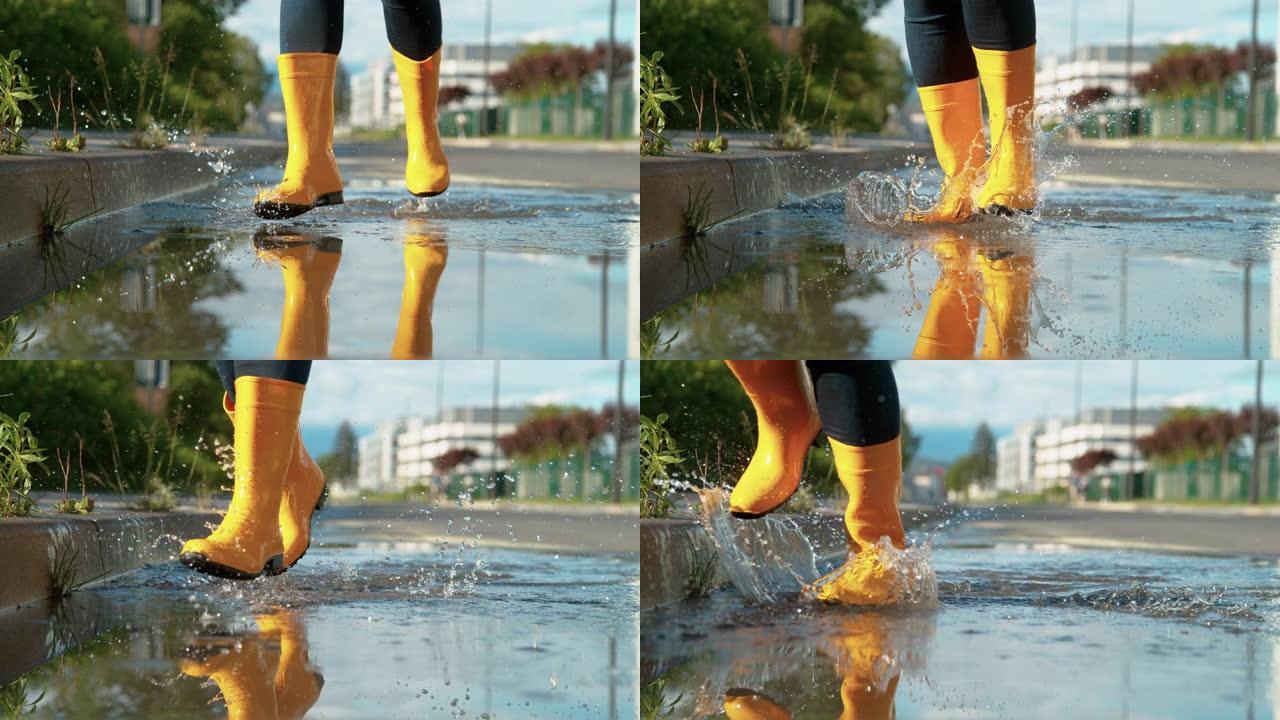 低角度: 穿着黄色雨靴的快乐女人穿过玻璃水坑。